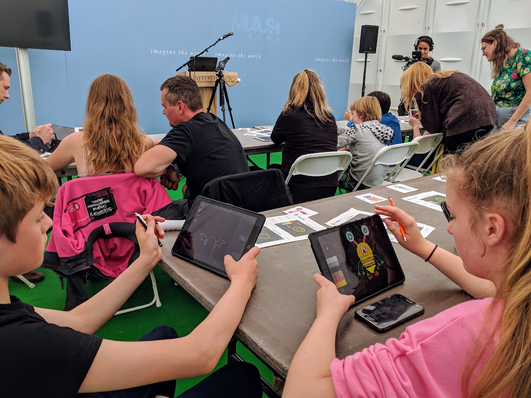 Young people using the application Tagtool to create animated monsters.